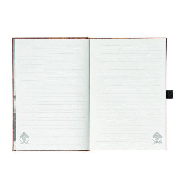 Carnet premium A5 Les Goonies ouvert sur des pages lignées avec motif pirate en bas de page.