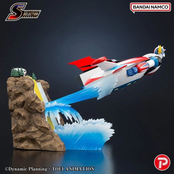 Vue latérale de Grendizer Scene Selection 02 quittant la base rocheuse avec traînée bleue